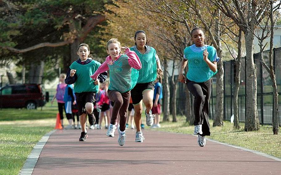 Members of the 'Go Girls Go' club run during a training session on Misawa Air Base, Japan. Organizers say the club offers the girls a chance to learn about self-respect, leadership and building positive self-identities.