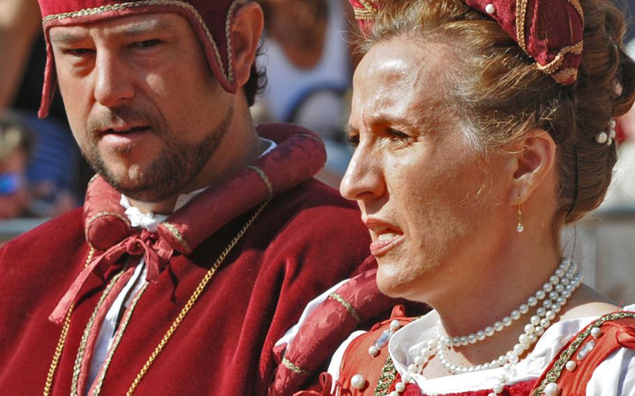 The lord and lady of Niola, Italy's Ciassa district, attend the festivities in fine attire. In real life, they are Massimo Debenedetti, a car company manager, and his wife.