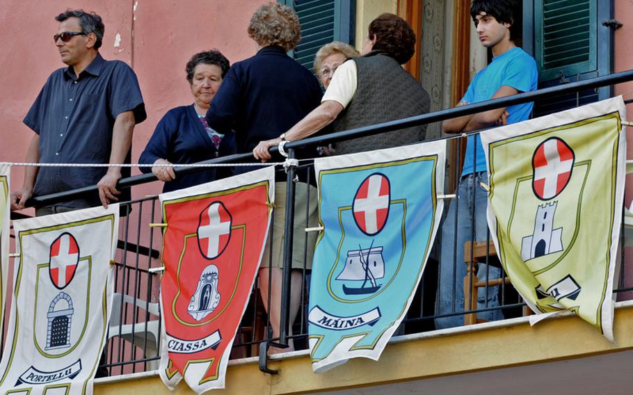 Flags of the old districts of Noli decorate a modern-day balcony during the town’s medieval festival.