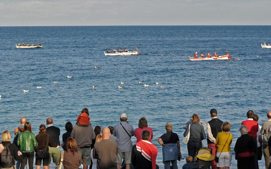 Local residents and tourists watch the traditional Regata Storica at Noli in September 2010.