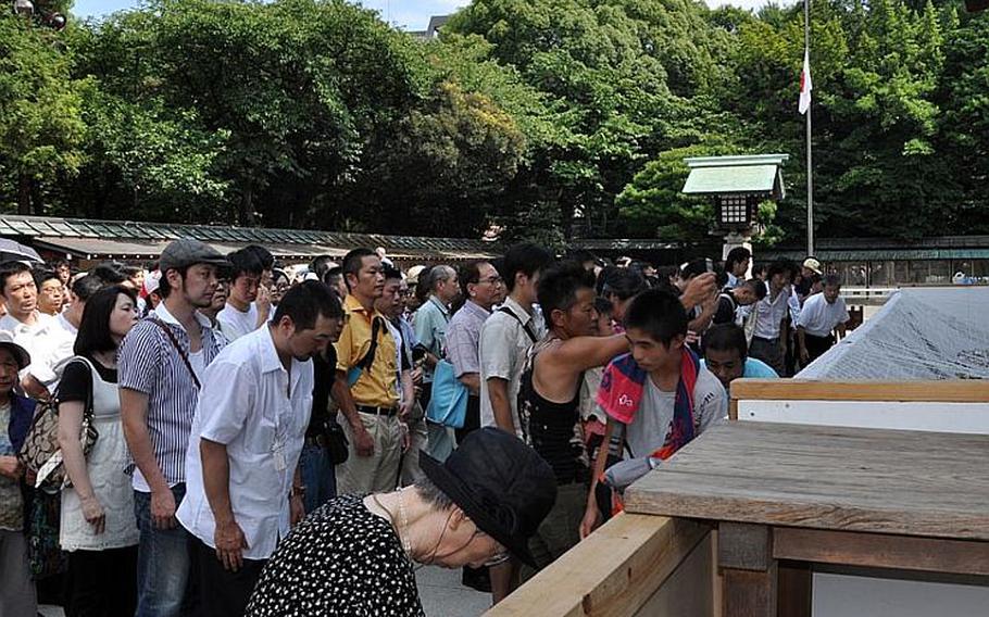 People gather at the shrine to pray and make their donations. The line to pray at the shrine extended all the way across the pavilion.