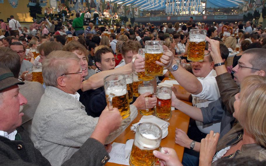 Revelers at a previous Oktoberfest in Munichraise a toast minutes after the first keg was tapped at noon. Most of the huge beer tents are overflowing before the festival even gets under way.