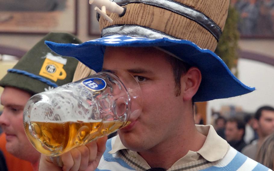 They sell funny hats at Oktoberfest, and people actually wear them. This young man probably wished that his keg hat actually held beer.