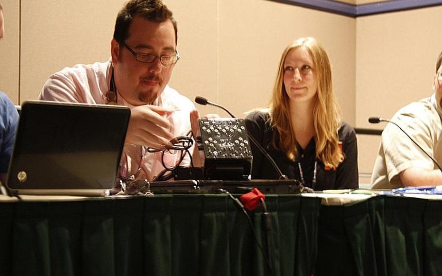 Mark C. Barlet, left, of the AbleGamers Foundation, unveils what he dubbed a landmark controller for the disabled during panel talk Aug. 30 titled "Gamers Doing Good." On the right is Stefanie Shea, director of Fun For Our Troops, a nonprofit that sends games to troops overseas.