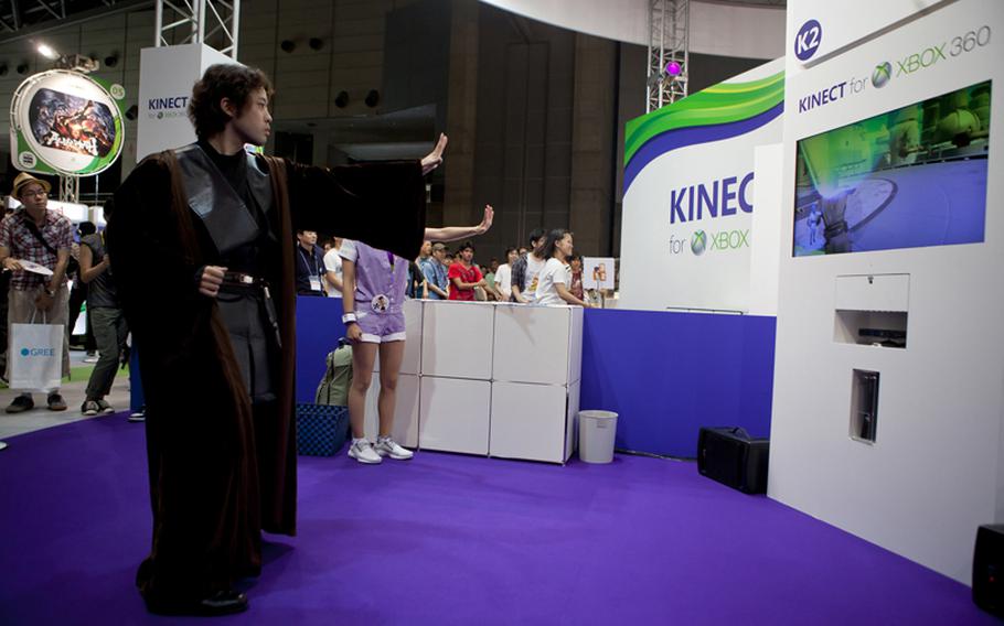 A truly hardcore Star Wars fan dressed in Jedi attire tests his force push on Microsoft&#39;s "Kinect: Star Wars" Saturday at the Tokyo Game Show 2011 held at Chiba Prefecture&#39;s Makuhari Messe convention center.