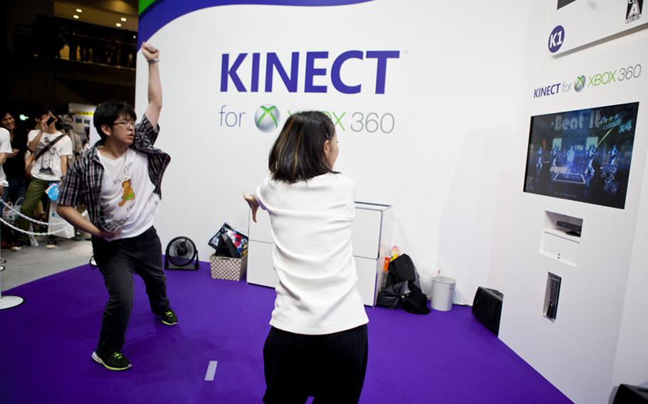 A gamer tries out his moves on the Microsoft Kinect version of "Michael Jackson: The Experience HD," Saturday at the Tokyo Game Show 2011 held at Chiba Prefecture&#39;s Makuhari Messe convention center.