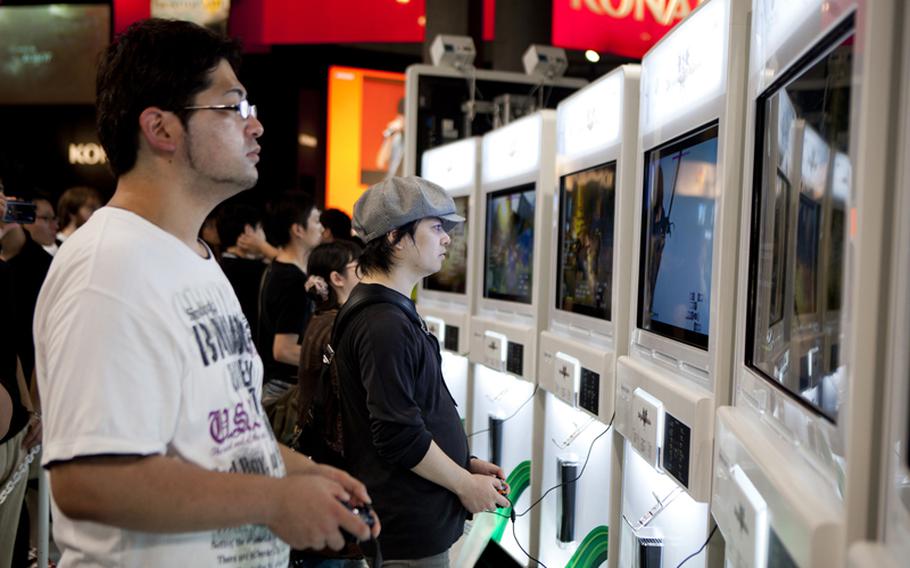 Gamers try out some of the new upcoming games at the Microsoft booth Saturday at the Tokyo Game Show at Chiba Prefecture's Makuhari Messe convention center.