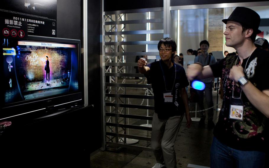 A gamer tries out his moves on the PlayStation Move version of "Michael Jackson: The Experience HD," Saturday at the Tokyo Game Show 2011 held at Chiba Prefecture's Makuhari Messe convention center.