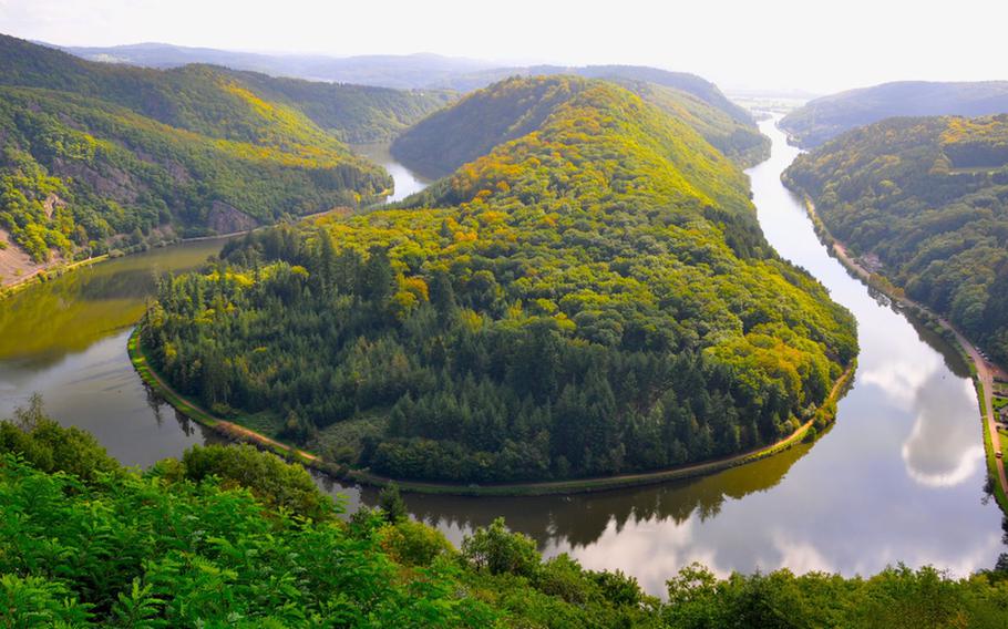 The perfect  view of Saarschleife, a U-shaped bend in the Saar River, near Mettlach, Germany. Benches on a cliff allow visitors to sit and take in the view.