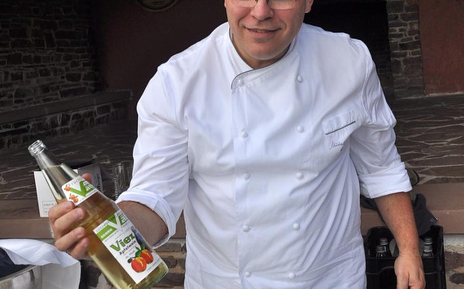 Michael Buchna, an employee at a hotel near the Saarschleife, prepares some Saarland specialties, including Apfelwein, a tart cider made from green apples. Buchna was preparing the lunch for a group of foreign officials visiting on a recent Friday.
