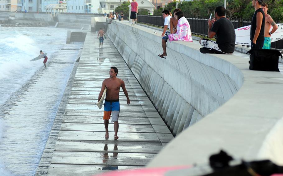 The surf at the seawall comes alive during typhoon season. Many American and Japanese surfers surf the shallow reef that extends about 100 yards from the walkway. In big surf, the walkway is inundated with spectators looking at the large surf and daredevil surfers.