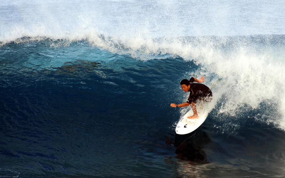 A local surfer rides a wave at the Seawall after a typhoon narrowly missed Okinawa. There are multitudes of surfing spots located along the seawall that really get hopping when the conditions are right.