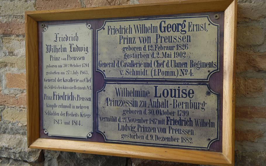 A sign outside the chapel at Burg Rheinstein displays the names of royal family members buried in the castle crypt. Prince Friedrich Wilhelm Ludwig, the royal prince of Prussia, bought the castle in 1823. Princess Louise was his wife, and Prince Georg was the couple's son.