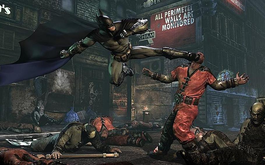 A flying kick takes out one of Batman's foes in 'Batman: Arkham City.'