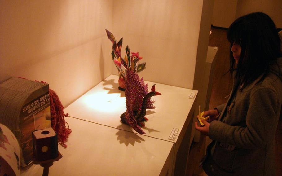 Natalya Jimenez looks at art made entirely of paper during a visit to the Jong IE Nara Paper Art Museum in Seoul.