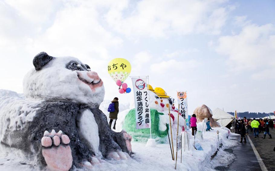 Local organizations build colorful snow sculptures that are on display all weekend at the annual hot air balloon festival in Ojiya, Japan.