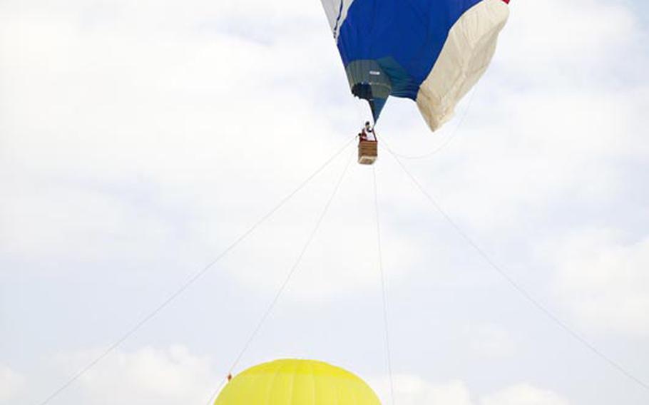 A balloon shaped like Doraemon, a popular Japanese manga character, takes visitors for a ride at the 2011 hot air balloon festival in Ojiya, Japan.