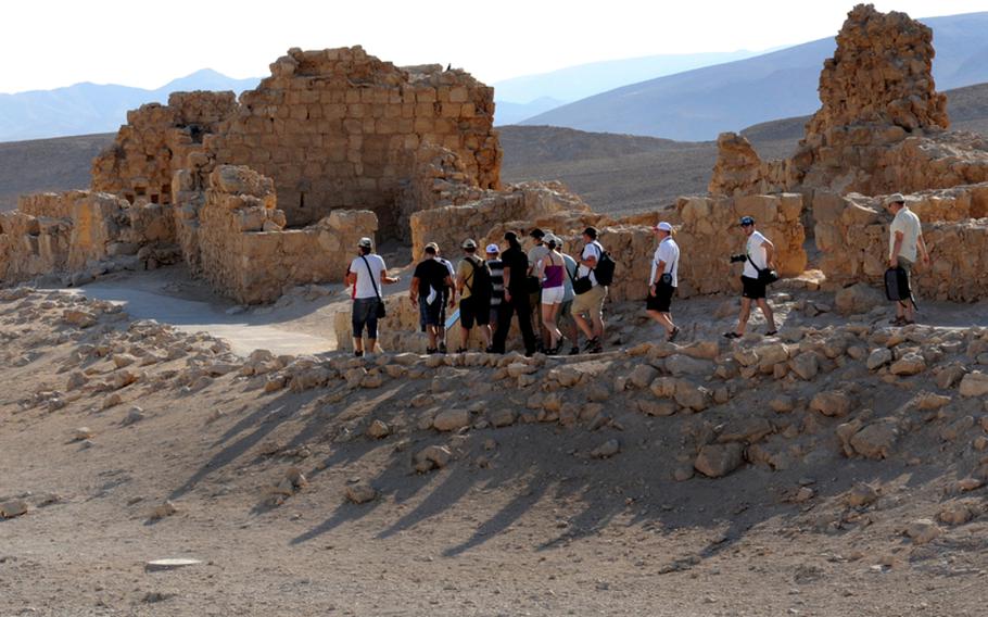 Tourists pass the ruins of the Western Palace at Masada, near the point where Roman legions breached the Jewish rebels' defenses during a months-long siege of the ancient fortress.