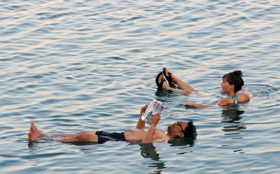 Tourists relax by floating in the Dead Sea near Masada. The water contains so much salt that no life can exist in it. Forget about swimming here; because of the salt, all you can do is float.