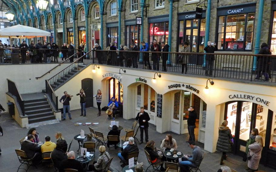 A crowd gathers to listen to musical entertainers at the Covent Garden markets. The entertainment is usually first-rate, so order a cup of coffee, grab a seat and relax after shopping for items by local artists at the Apple Market.