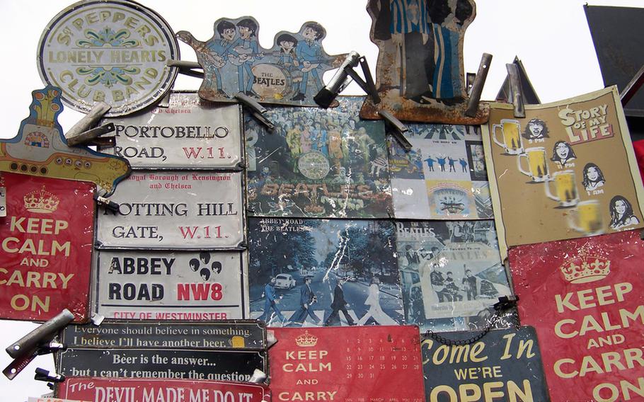 A dealer in antique and reproduction signs has an eye-catching display at the Portobello Road Market.