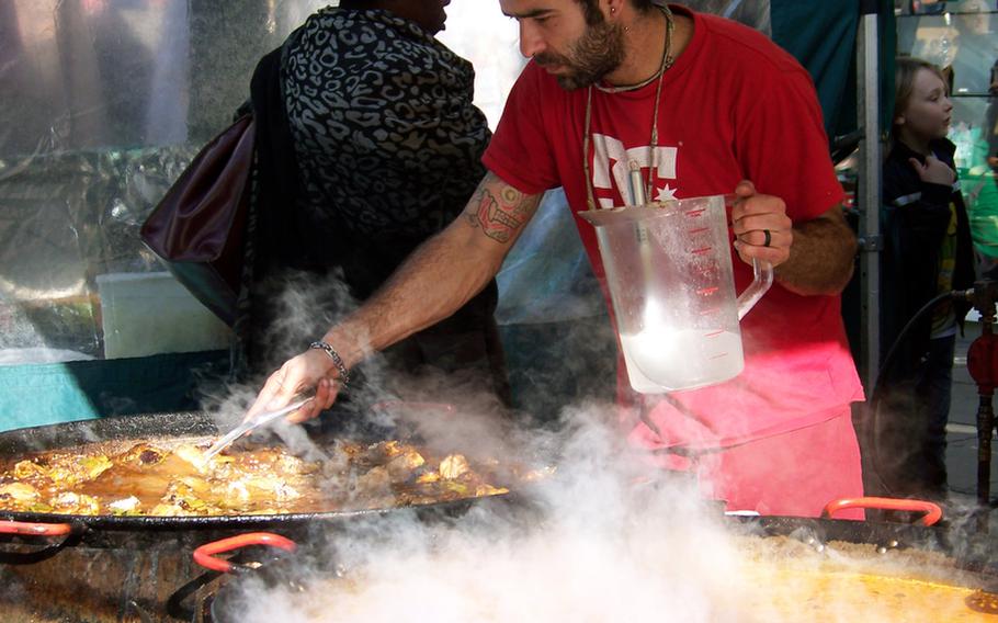 A vendor stirs a steamy cauldron of stew at the outdoor Portobello Road Market in London's pretty Notting Hill area. Freshly prepared food as well as fresh produce are sold at the market. In addition, the blocks-long market is flanked by some cafes and restaurants.