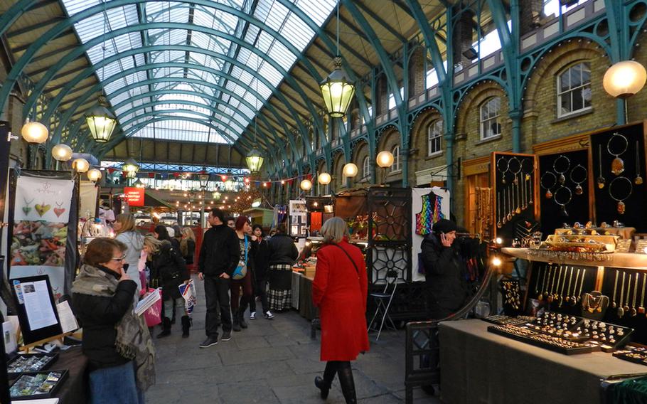 Shoppers and local artists mingle at Covent Garden's Apple Market. While this Apple Market showcases local artists' handicrafts, another market at Covent Garden, the Jubilee Market, sells T-shirts and other items made mostly from other countries.