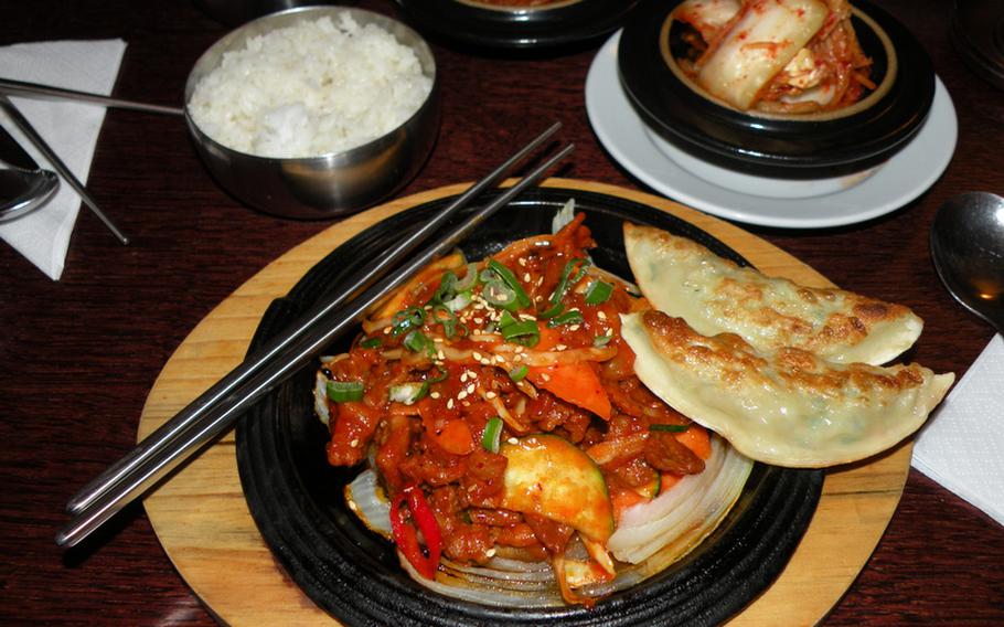 The spicy pork bulgogi served on a sizzling plate with a side of cabbage kimchi and two Korean-style pork-filled fried dumplings turned out to be a great meal during a recent visit to Little Seoul in Cambridge, England.