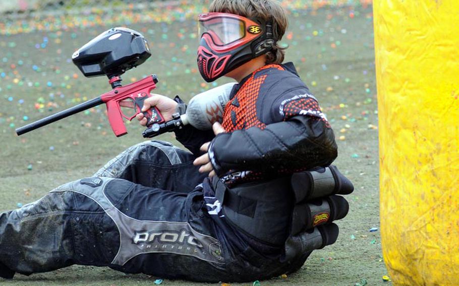 A player checks himself over after being struck in the chest with a paintball round during a game Feb. 25, 2012, at Kadena Air Base, Okinawa.