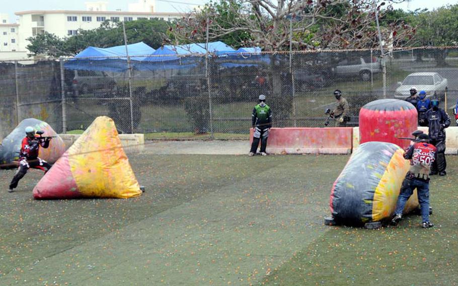 The last two players in a game of speedball paintball battle it out behind inflatable pylons at the Kadena Air Base paintball field. The field gets a lot of use over the weekends, and the sport has grown in popularity over the past few years.