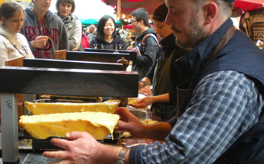 A taste of heaven:a Kappacasein food vendor shaves melting Ogleshield cheese onto a bowl of potatoes.