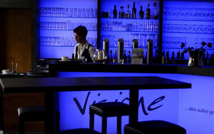 Vanessa Lorenz performs her duties behind the colorful bar at Visione inside the Haus des Bürgers.