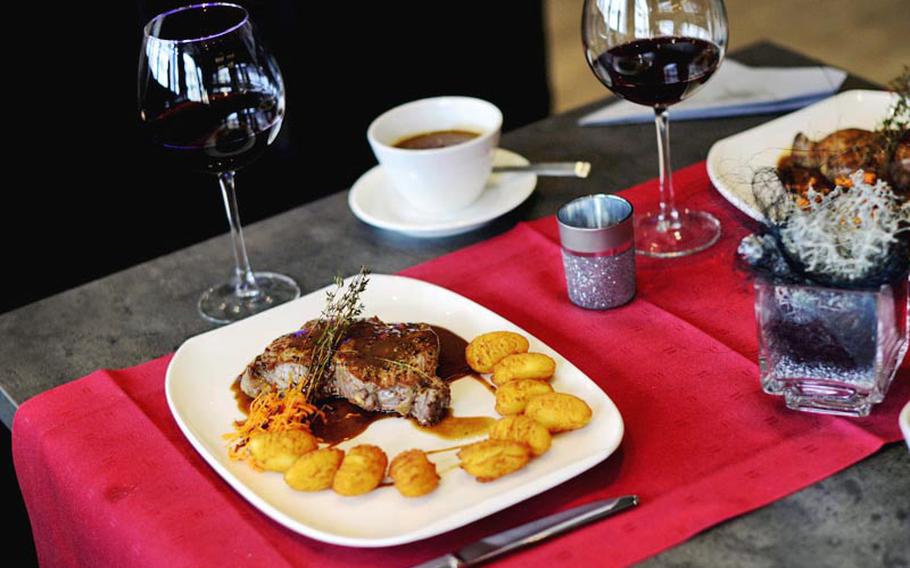 The half-pound Argentinian rump steak with pepper sauce, potatoes dauphine and a glass of wine is one of Visione's signature dishes.
