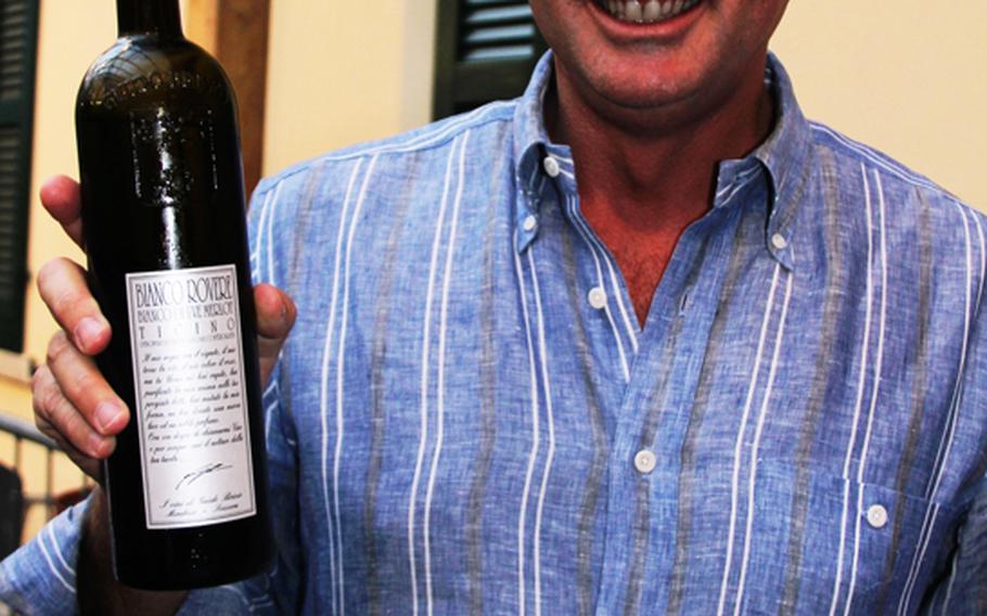 Wine maker Guido Brivio shows pride in his 2011 wine. Brivio was among the vintners selling his wine at the Sagra dell'Uva annual grape festival in Mendrisio, Switzerland.