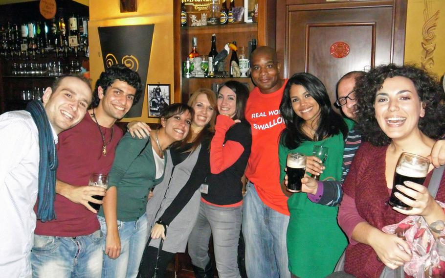 Members of the social club British Community gather at Morrigan Pub in the Vomero district of Naples, Italy, for beer, socializing, conversation - all in English - and to play the occasional bar game.