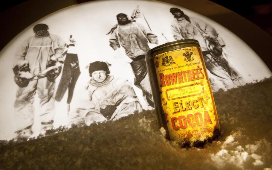 The original Rowntree's cocoa can that was found next to the frozen body of British explorer Captain Robert Scott, pictured in the background, who died during an attempt to reach the South Pole in 1912.