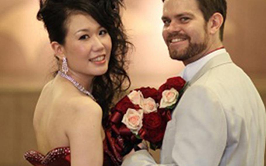 Tomoko and Mike wore two different outfits at the reception. Here, she wore a red cocktail gown while Mike went casual with a red cravat. All of their clothing was rented from Hotel Castle Kumamoto in Japan.