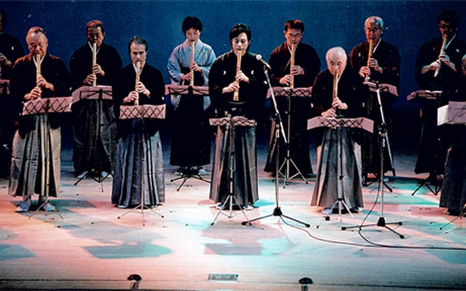 Fujiwara Dozan, center, plays traditional Japanese songs with local shakuhachi players during a recent trip to Sasebo.
