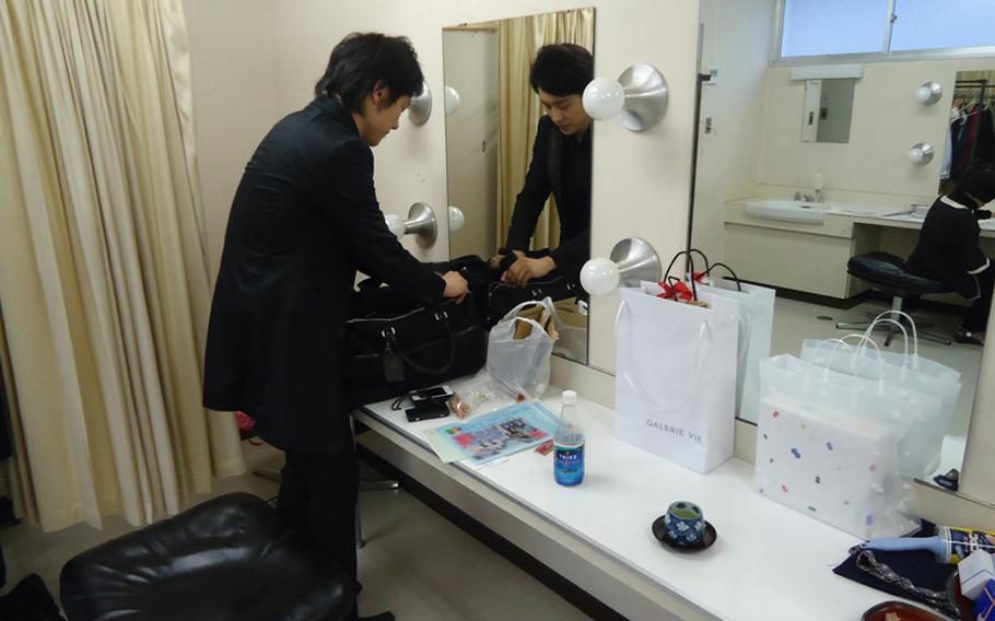 Fujiwara Dozan packs up his bamboo flute after a recent concert in Sasebo. He will play again on June 2 in Japan. 