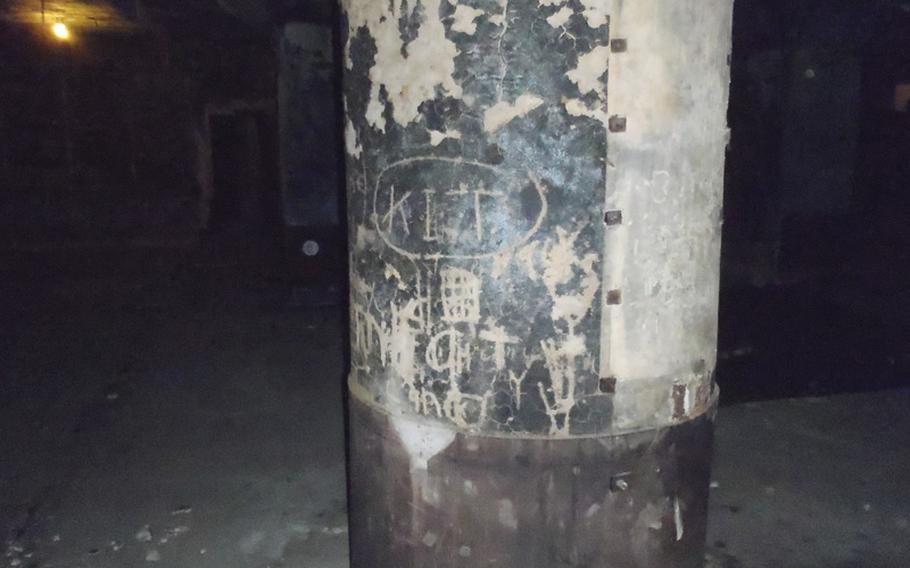 In the main chamber of the burned-out air defense command center that served most of southern Japan during World War II, occupying American forces are believed to have written in the soot.
