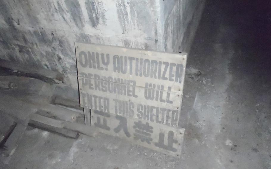 A sign that once kept people from the bunker complex and dates back to just after the Japanese surrender sits under about 50 years of dust in the charred air defense command center located across the street from Sasebo Naval Base.