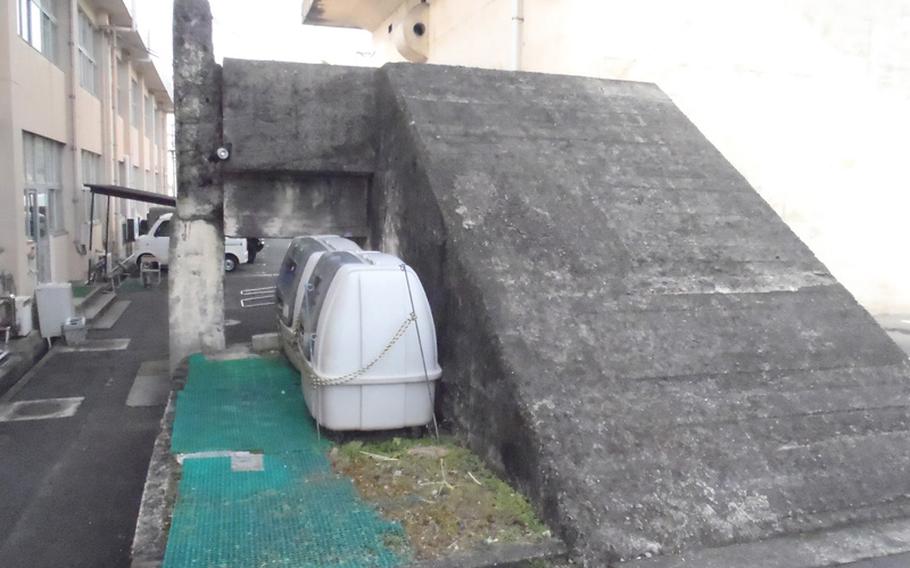 The main entrance of the burned-out air defense command center that served most of southern Japan during World War II is behind a Japan Maritime Self-Defense Force building near Sasebo Naval Base.