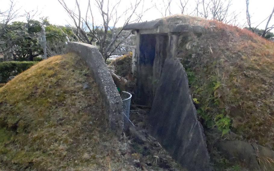 An alternative entrance to the burned-out WWII air defense command center, in view of the main gate to Sasebo Naval Base.