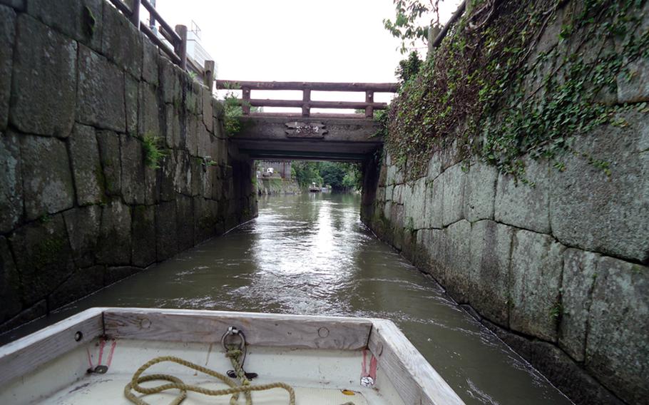 In Yanagawa, the long boats squeak through tight passages and under old bridges.