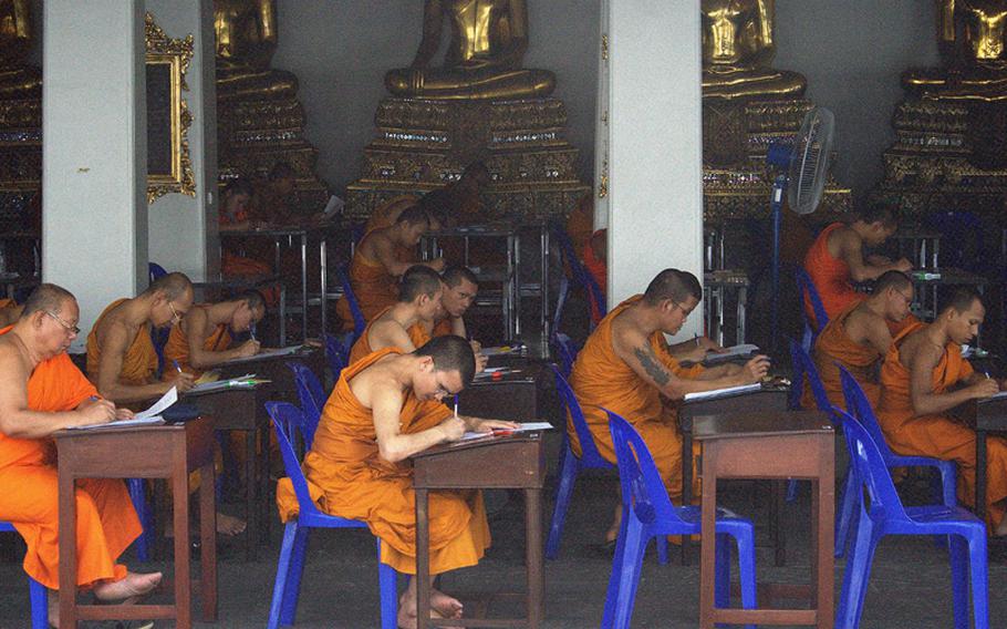 Monks study in the open classrooms among the temples at Wat Po.