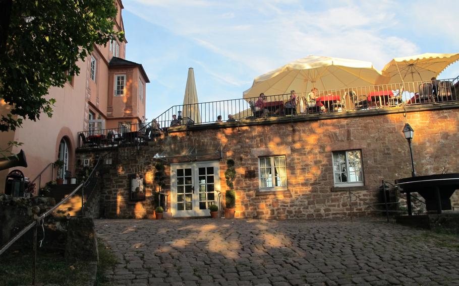 The Hirschhorn Castle restaurant, near Heidelberg, Germany, from the entrance below. The restaurant's terrace provides a stunning view of the Neckar River below and the hills of the Odenwald.