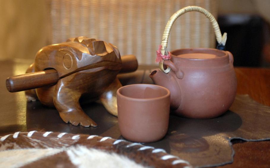 Tables that are out of easy view of the Manitou staff come adorned with a noisemaker to alert your waiter when you need something. Pictured is a frog that customers can rub the wooden peg along its back to make a croaking noise. Other tables come equipped with Indian rainmakers.