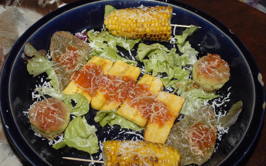 Manitou's mixed starter platter is a perfect sized dish for two. It features plantains, grilled corn-on-the-cob, potato balls and cactus steaks.