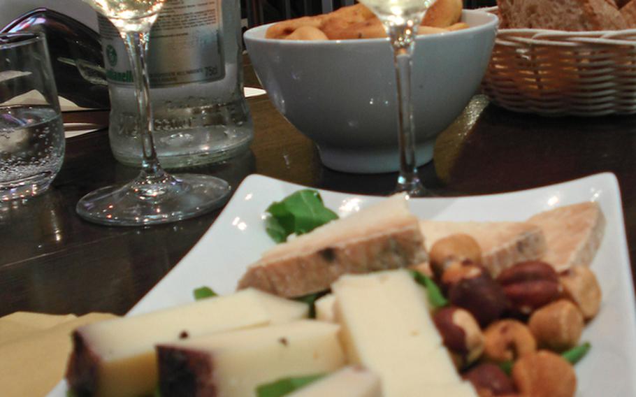 A starter plate of pungent cheeses is paired with chilled Grego spumante, crisp and light with a subtle hint of flower pollen and honey, at the Feudi di San Gregorio Wine Bar in the Vulcano Buono shopping mall in Nola, Italy.
