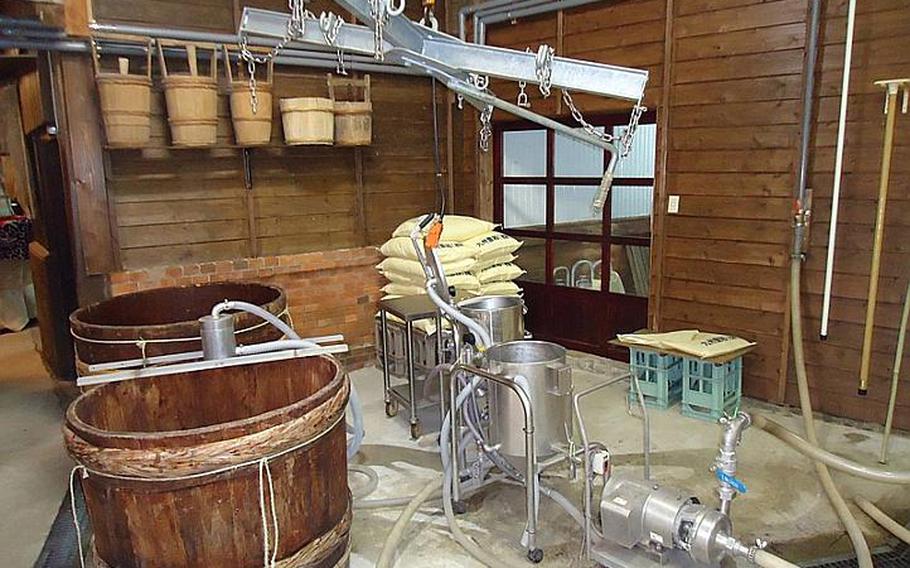Sake enthusiasts can drink sake surrounded by brewery equipment during a brewery tour and tasting like this one at Sasebo's Umegae sake brewery on Feb. 9. Sake breweries across Japan offer tours and tastings upon request.